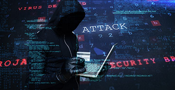 A composite image of a hacker holding a laptop and credit card.