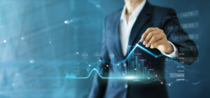 Businessman drawing a growth graph and progress of business while analyzing financial and investment data.