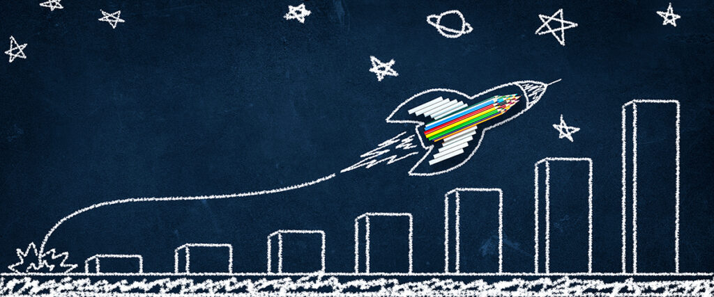 A chalkboard drawing of increasing stacks with a rocket flying overhead.