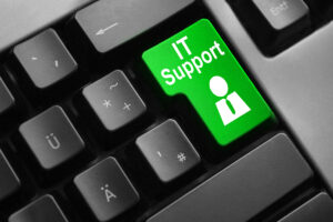 A black computer keyboard with a green IT Support button.