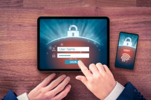 A person with a tablet and phone to unlock using multifactor authentication.