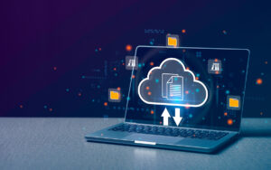 A cloud icon on a laptop screen downloading and uploading files.